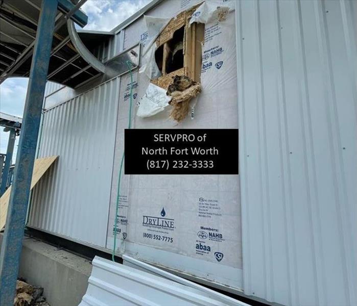 image containing exterior building siding damaged