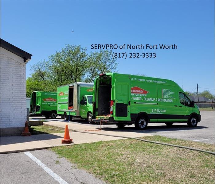 image of three SERVPRO vans in a parking lot