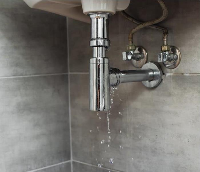 image of a bathroom sink showing signs of a water leak