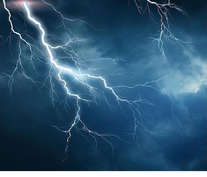 Extreme Lightning bolting across a dark cloudy sky